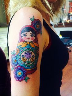 a woman with a colorful tattoo on her arm