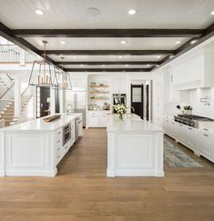 a kitchen with white cabinets and an island in the center is featured on instagram