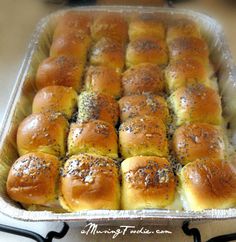 a pan filled with rolls sitting on top of a stove