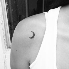 a woman with a crescent tattoo on her shoulder