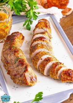 sliced pork loin sitting on top of a cutting board next to some parsley