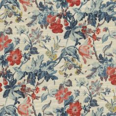 an image of a flowery fabric with red, blue and yellow flowers on it