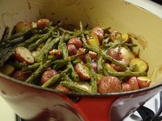 a pot filled with potatoes and green beans