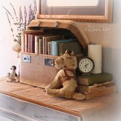 a teddy bear sitting on top of a book shelf next to a clock and books