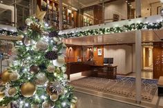 a decorated christmas tree in the lobby of a cruise ship with lights and decorations on it