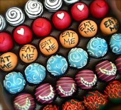 cupcakes decorated with the words eat me, eat me and heart shaped candies