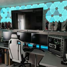 a desk with two computer monitors and a gaming chair in front of the monitor screen