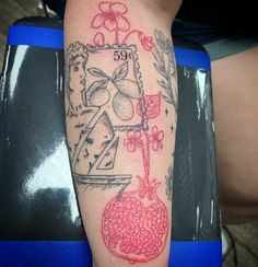 a tattoo on the arm of a woman with flowers and fruit in it's vase