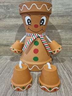 a gingerbread man made out of clay sitting on top of a wooden table