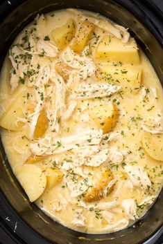 a crock pot filled with chicken, potatoes and parmesan cheese in the slow cooker