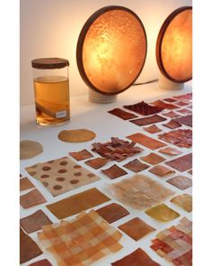 two lamps are sitting on top of a table covered in different types of glass tiles