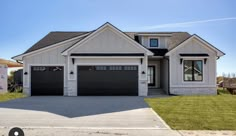 a large house with two garages in the front and one on the other side