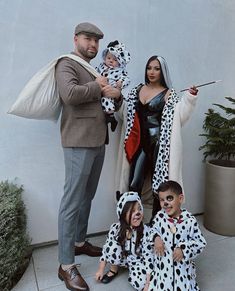 a man and two children dressed in dalmatian costumes