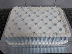 a large white cake with blue decorations on it