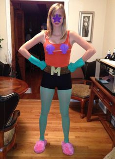 a woman is standing in front of a mirror with her hands on her hips and wearing blue tights