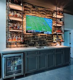 a bar with a large football game on the wall