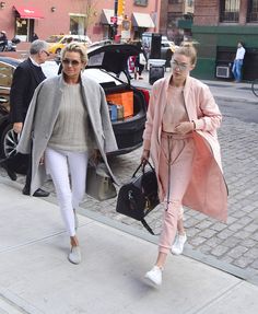 two women are walking down the street together