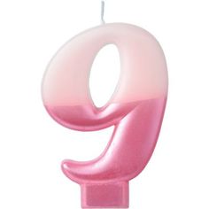 the number nine candle is pink and white