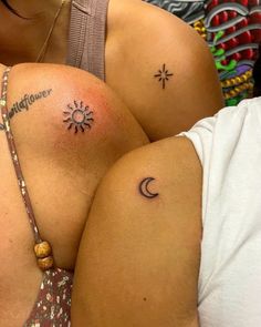 two women with sun and moon tattoos on their backs