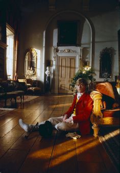 a woman sitting on the floor in a room