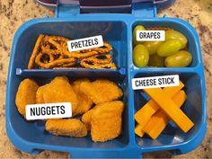 a blue lunch box filled with grapes, pretzels and cheese sticks