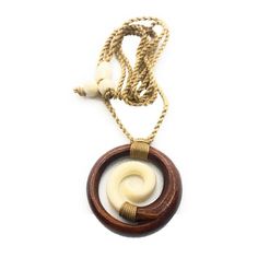 A beautiful Spiral Necklace with Koa Wood and Cow Bone. Made with Hawaiian Koa making this a favorite at Makana Hut. With adjustable cored for the perfect fit. The Spiral represents Koru, which is the fern frond as it opens bringing new life and purity to the world. The closed outer circle is the circle of life. It also represents peace, tranquility, spirituality, family as well as regrowth or new beginnings/journey. Spiral Form Measures: Width: 40mm x 40mm Material: Koa Wood and Cow Bone Featur Handmade Vintage Spiral Jewelry, Handmade Spiral Necklaces For Beach, Handmade Spiral Nature-inspired Jewelry, Unique Brown Spiral Jewelry, Adjustable Spiral Jewelry For Beach, Spiral Form, The Circle Of Life, Fern Frond, Spiral Necklace