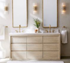 a bathroom with two sinks and mirrors on the wall