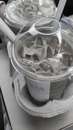 two plastic containers filled with ice cream on top of a table