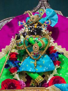 an idol is displayed on a colorful cloth