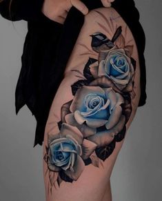 a woman's thigh with blue roses on it