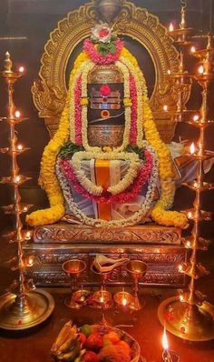 the statue is decorated with flowers and candles