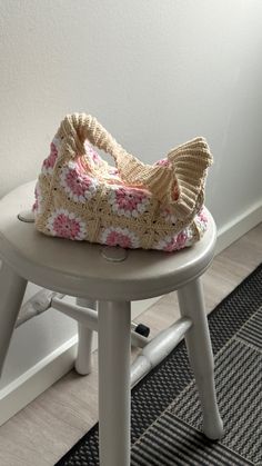 a crocheted bag sitting on top of a stool