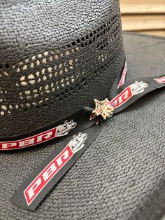 Support your favorite PBR cowboys with the Bullhide No Pressure Black Straw Cowboy Hat. A perfect cowboy hat to wear to any rodeo event, it has a 4 1/2" brim and a 4 3/4" cattleman's crown bordered with a Professional Bull Rider's ribbon band and hat pin. Note: As a natural product, palm straw may vary in color so hat may be different than in picture. Professional Bull Riders, Rodeo Events, Country Strong, Straw Cowboy Hat, Western Store, Western Cowboy Hats, Bull Riders, Cowgirl Western, Western Hats