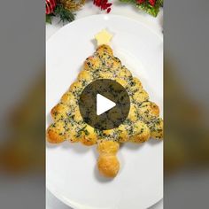 a white plate topped with food on top of a christmas tree shaped pastry cut in half