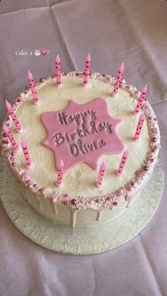 a birthday cake with pink candles on it