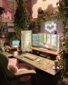 two computer monitors sitting on top of a desk