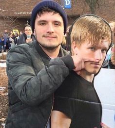 a young man is taking a selfie in front of a mirror with his reflection