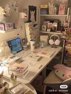 a white desk topped with lots of clutter