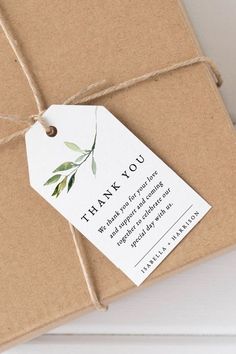 a thank you tag attached to a brown gift box with twine on the top