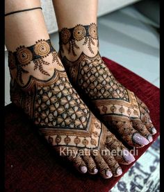 the feet are decorated with henna designs