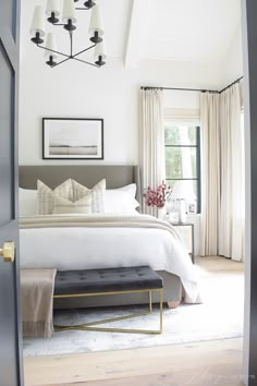 a bedroom with white bedding and beige drapes on the window sill is featured in instagram