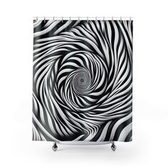 a black and white shower curtain with an abstract swirl design on the bottom half of it