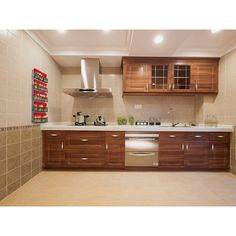 a kitchen with wooden cabinets and white counter tops