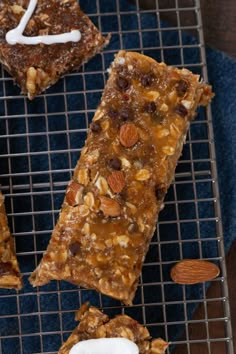 three bars on a cooling rack with almonds and marshmallows next to them