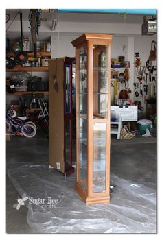 a tall wooden grandfather clock sitting inside of a garage