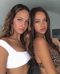 two beautiful young women standing next to each other