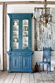 an old china cabinet is painted blue