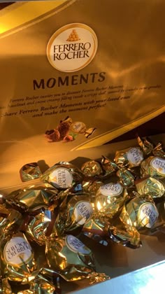 some gold foil wrapped chocolates are sitting on a table next to an award plaque