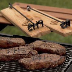 some steaks are cooking on a grill