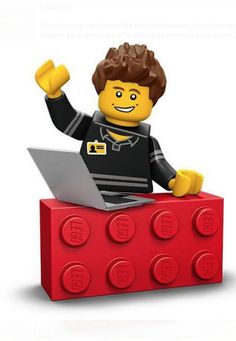 a lego man with his arms in the air and one hand raised up, sitting on top of a red block